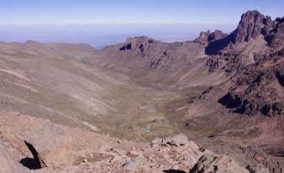 Trekkers on the 5-Day Mount Kenya Trek via Sirimon Route approaching Point Lenana, guided through alpine terrain with stunning views
